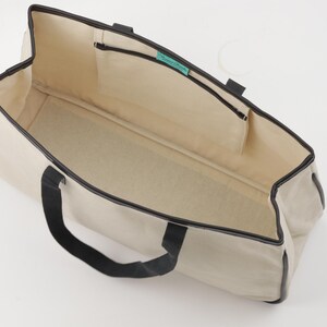 a white and black bag on a white surface