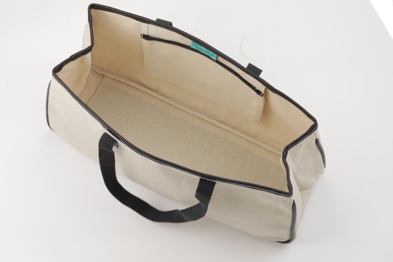a white and black bag on a white surface