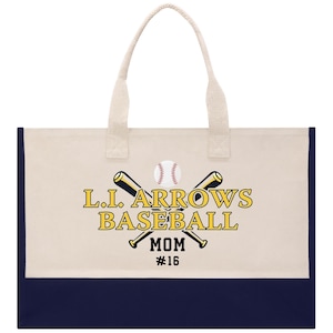 May include: Cream-colored tote bag with navy blue bottom panel and cream-colored handles. The bag features the text "L.I. ARROWS BASEBALL MOM #16" with crossed baseball bats and a baseball graphic.