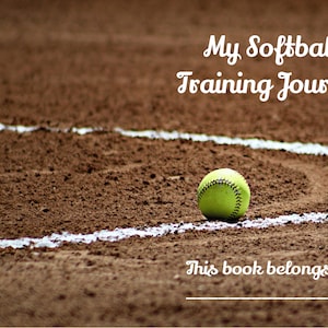 May include: A yellow softball sits on a brown dirt baseball field with a white line around it. The text "My Softball Training Journal" is at the top of the image and the text "This book belongs to:" is at the bottom of the image.