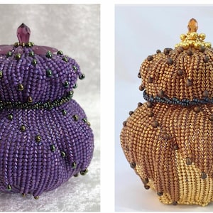 May include: Two beaded decorative boxes, one purple and one gold, with intricate designs and a domed lid.