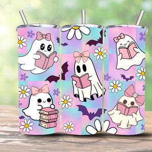 May include: A tumbler with a whimsical design featuring cartoon ghosts reading books. The ghosts have pink bows and are surrounded by daisies and bats on a pastel pink, blue, and purple checkered background. A silver straw is inserted in the lid.