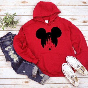 May include: Red hooded sweatshirt with a black silhouette of Mickey Mouse ears and the Disney castle inside the ears.