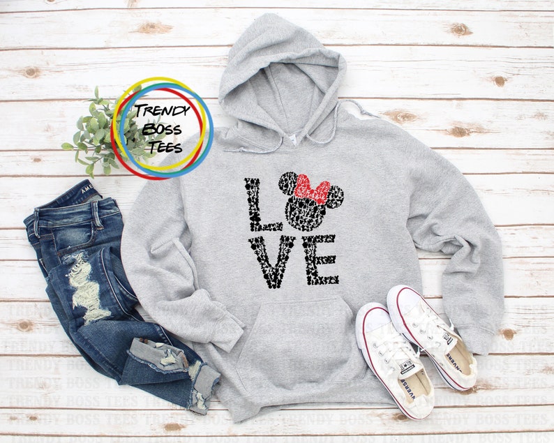 May include: Grey hooded sweatshirt with a black and white graphic of Mickey Mouse ears and the word "LOVE" spelled out with Mickey Mouse heads. The graphic has a red bow on top of the Mickey Mouse head.