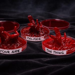 May include: A set of three ceramic mugs with a speckled, matte finish in cream, light grey, and dark grey. Each mug has a simple, minimalist design, ideal for tea or coffee.