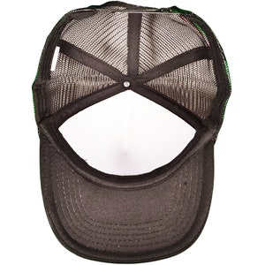 May include: Black mesh trucker hat with a black brim and a white interior. The hat has a green and black trim around the mesh panel.