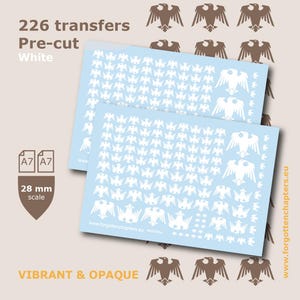 May include: Two light blue sheets containing 226 pre-cut white eagle transfers for 28 mm scale models. The sheets feature various sizes of eagle silhouettes, with text including 226 transfers, Pre-cut, White, A7, and www.forgottenchapters.eu.