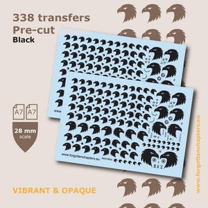 May include: Two light blue sheets containing 338 pre-cut black eagle head transfers in 28 mm scale. The sheets feature various sizes of eagle heads, small circular icons, and the text 338 transfers, Pre-cut, Black, A7, and www.forgottenchapters.eu.