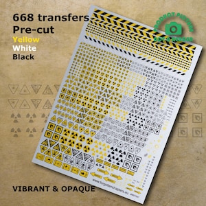May include: A sheet of 668 pre-cut transfers featuring a variety of warning signs in yellow, white, and black. The signs include radiation symbols, fire hazard symbols, and other safety symbols.