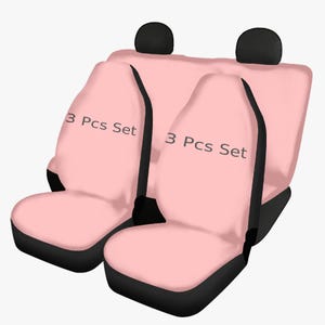 Puede incluir: Un juego de tres fundas para asientos de coche de color rosa con ribetes negros. Las fundas tienen el texto "3 Pcs Set" impreso en ellas.