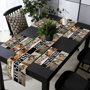 May include: A black dining table set with a table runner and placemats, all featuring personalized photo collages and the text "YOUR PICTURES AND TEXT HERE." A small potted plant and a white mug are on the table. Black chairs surround the table.