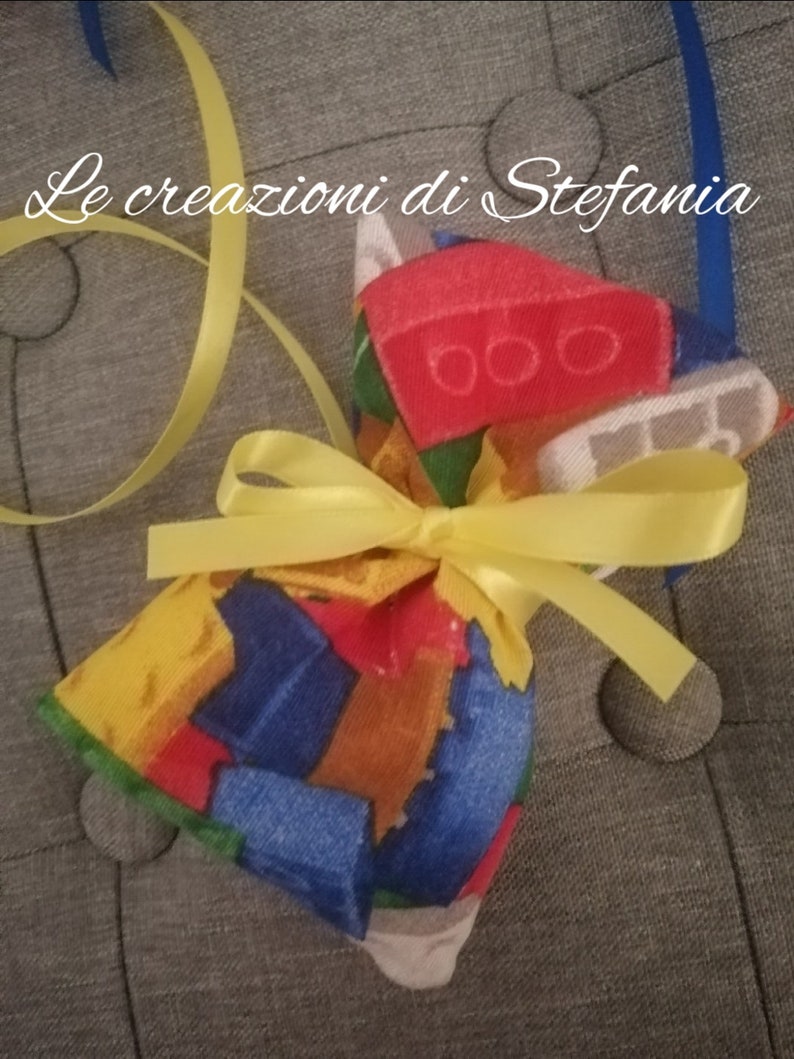 20 bags bearing confetti or lego-themed candy in cotton
