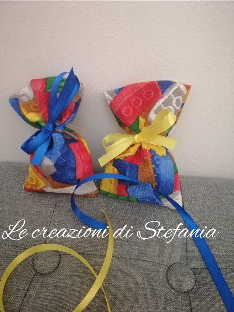 20 bags bearing confetti or lego-themed candy in cotton