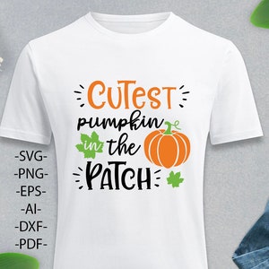 May include: A white short-sleeved t-shirt featuring a graphic design with the orange and black text "CUTEST pumpkin in the PATCH". The design includes an orange pumpkin illustration with green leaves and the file formats SVG, PNG, EPS, AI, DXF, and PDF.