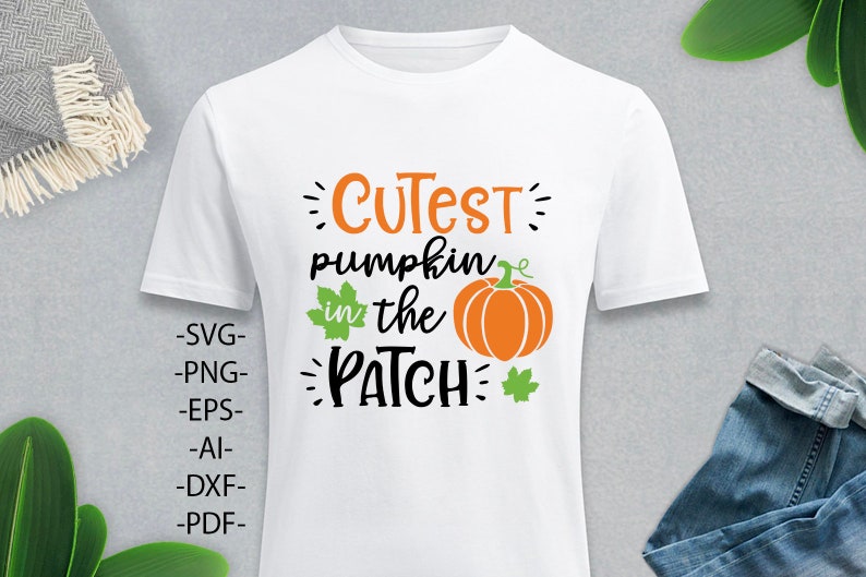 May include: A white short-sleeved t-shirt featuring a graphic design with the orange and black text "CUTEST pumpkin in the PATCH". The design includes an orange pumpkin illustration with green leaves and the file formats SVG, PNG, EPS, AI, DXF, and PDF.