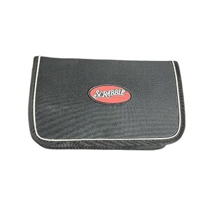May include: A black Scrabble game carrying case with a white trim and a red oval logo. The case is rectangular with rounded corners. The Scrabble logo is in the center of the case.