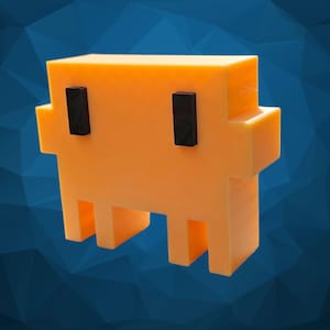 May include: A three-dimensional orange pixelated ghost figure with a blocky, rectangular body and two small, vertical black rectangular eyes. The object features a flat top, protruding side arms, and four short legs creating a hollow space.