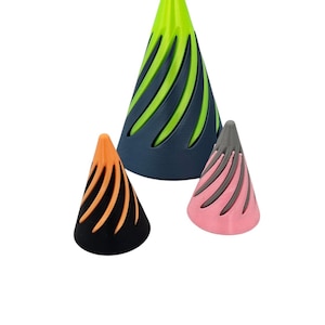 May include: Three cone-shaped objects with a swirl pattern. The largest cone is green with black swirls, the middle cone is orange with black swirls, and the smallest cone is pink with gray swirls.