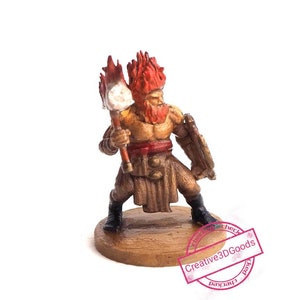 May include: A miniature warrior figurine with a red beard and hair, holding a torch. The warrior wears a brown tunic, red sash, and a shield. The figurine is on a round, wooden base.