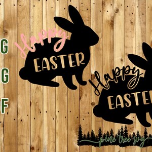 May include: Black silhouette of two bunnies with the text "Happy Easter" in pink script. The bunnies are on a woodgrain background.