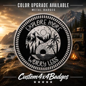 May include: A circular black and white metal badge featuring a yin-yang design with mountains and pine trees on one side and palm trees with a sun on the other. The text reads EXPLORE MORE WORRY LESS. The badge has a textured border.