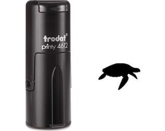 May include: Black self-inking stamp with a silhouette of a sea turtle. The stamp is labeled "trodat printy 4612".