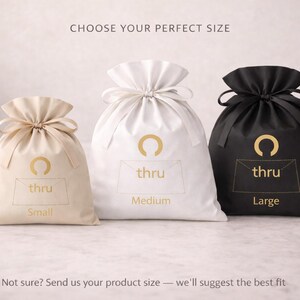May include: Three drawstring bags in beige, white, and black, each labeled with a size: Small, Medium, and Large. The bags have a gold logo and the word "thru" printed on them. The image includes text that says "Choose Your Perfect Size."