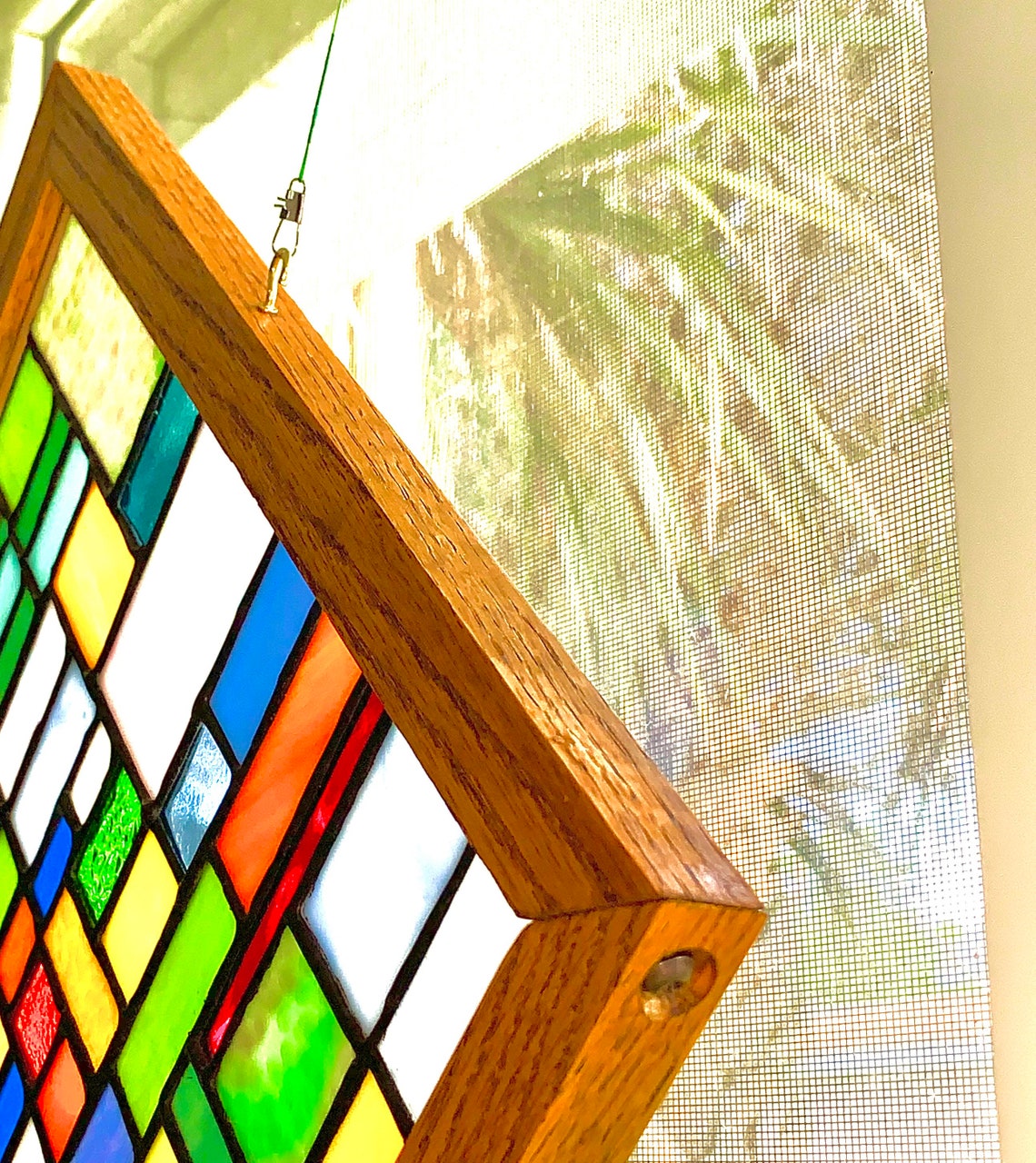 Stained glass panel mounted in custom red oak wood frame. Etsy