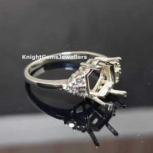 May include: Silver ring setting with a hexagonal center stone and small round stones on the band.  KnightGemsJewellers is printed on the band.