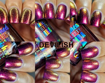 May include: A bottle of nail polish with a holographic finish. The bottle is labeled "Polished Pretty" and "Devilish". The polish is a deep purple with gold and red shimmer.