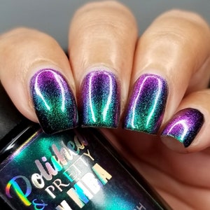 May include: A bottle of nail polish with a green, purple, and blue iridescent finish. The bottle is labeled "Polished & Pretty" and "MIBA".