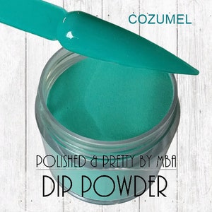 May include: A jar of teal blue dip powder labeled "COZUMEL" and "POLISHED & PRETTY BY MBA DIP POWDER".