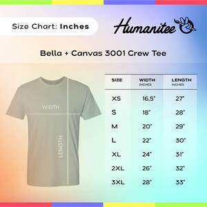 May include: A size chart for a Bella + Canvas 3001 crew tee by Humanitee. The graphic displays a light gray t-shirt with width and length lines, alongside a table listing sizes XS through 3XL with corresponding measurements in inches.