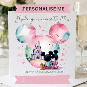 May include: A square greeting card featuring a watercolor-style Mickey Mouse head silhouette containing a castle and two cartoon mice sitting together. Text reads: PERSONALISE ME, Making memories together, and Happy 1st Anniversary, Love Laura.