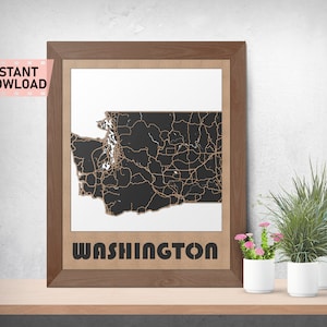 May include: A framed print of a black and white map of Washington state with the word "WASHINGTON" printed below the map. The map is surrounded by a brown wooden frame.