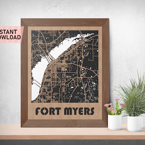 May include: A framed wood print of a map of Fort Myers, Florida. The map is in black and white with brown lines and text. The frame is brown wood.