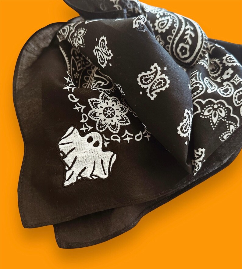 May include: Black bandana with a white ghost and paisley pattern.