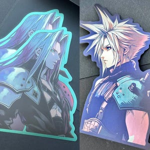 May include: Two holographic stickers featuring a character from the Final Fantasy video game series. The character has spiky blonde hair and is wearing a black and blue outfit. The stickers are on a black background.