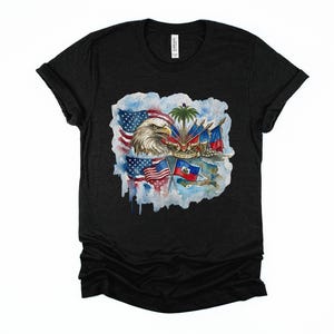 May include: Black t-shirt featuring a watercolor design with an American bald eagle, American flags, and Haitian flags. The design includes a palm tree and other elements, creating a patriotic and cultural fusion. The shirt is made of a soft material.