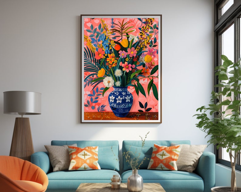 May include: A painting of a blue and white vase filled with a colorful bouquet of flowers. The flowers are arranged in a loose, natural style and include pink, yellow, orange, and red blooms. The background is a soft pink with a subtle floral pattern.