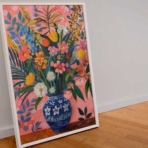 May include: A framed painting of a colorful floral arrangement in a blue and white patterned vase. The flowers are arranged in a vase with a pink background.