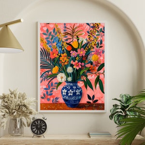 May include: A painting of a blue and white vase filled with a colorful bouquet of flowers. The flowers are arranged in a vase with a floral pattern. The background is a pink and white floral pattern.