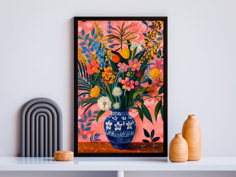 May include: A painting of a blue and white vase filled with a colorful bouquet of flowers. The flowers are pink, yellow, orange, red, and white. The vase is on a table with a pink background.