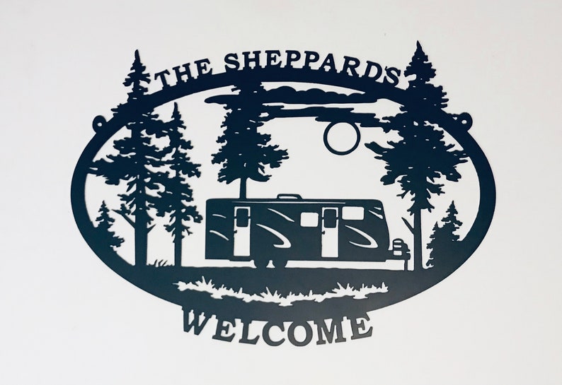 May include: Black metal silhouette of a camper van parked in a forest with trees and a full moon. The text "The Sheppards" is above the scene and "Welcome" is below.