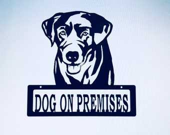 May include: Black metal silhouette of a dog's head with a sign that reads "DOG ON PREMISES".