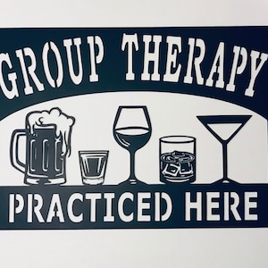 May include: Black metal sign with the text "GROUP THERAPY PRACTICED HERE" in white lettering. The sign features a beer mug, a wine glass, a shot glass, a glass of whiskey with ice, and a martini glass.