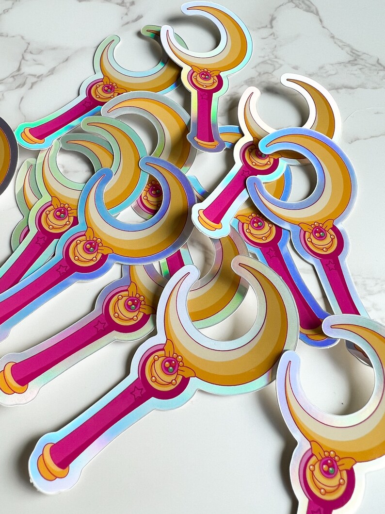 Close up of moon stick wand sticker, showing the vibrant rainbow colors from the holographic effect of the vinyl decal.