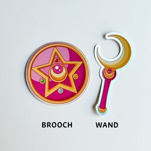 Holographic Crystal Star Brooch and Moon Stick sticker inspired by Sailor Moon. This vibrant sticker captures the iconic elements of the beloved 90s anime.