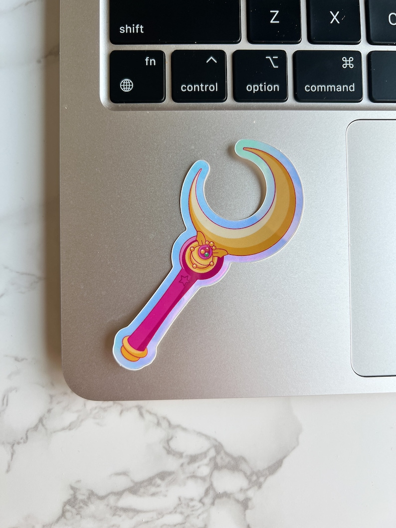 Holographic Moon stick wand sticker on top of a laptop. This sticker is the ideal size for laptops and water bottles.