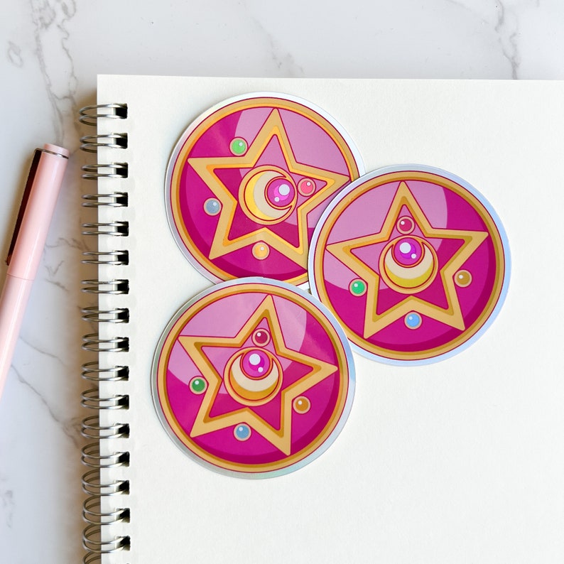 Adorn your accessories with celestial charm! Our Crystal Star Brooch sticker pays homage to Sailor Moon's iconic symbol, adding a touch of magic to your daily routine. Perfect for fans and fashionistas alike.